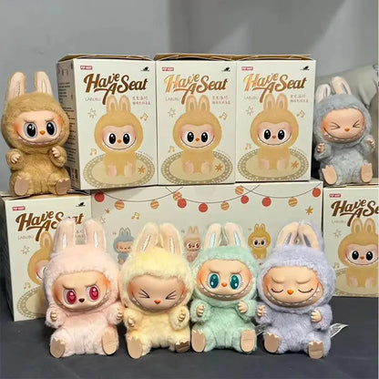 Labubu Plush toys and boxes with 'Have a Seat' branding on a gray background