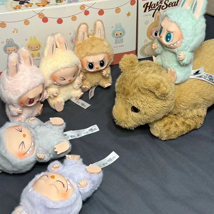 Labubu. Collection of plush toys with bunny ears on a dark surface, with packaging in the background.