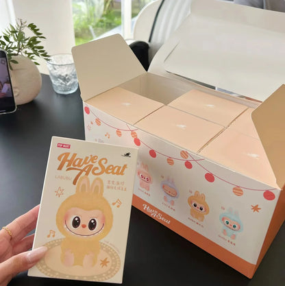 Labubu have a seat. Product packaging with a cute character design on a table.