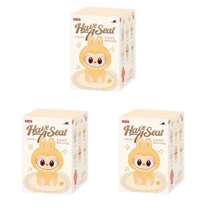 Three boxes of 'Have A Seat' Labuu with cartoon character design on a white background