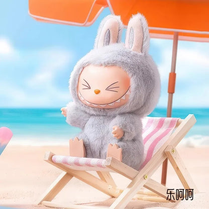Labubu have a seat. Plush toy with rabbit ears sitting on a beach chair with ocean view